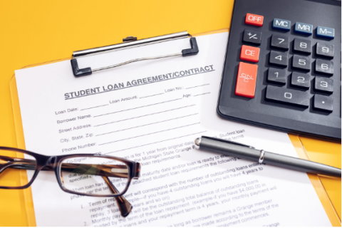 A pair of glasses alongside a pen and calculator on top of a student loan agreement contract 